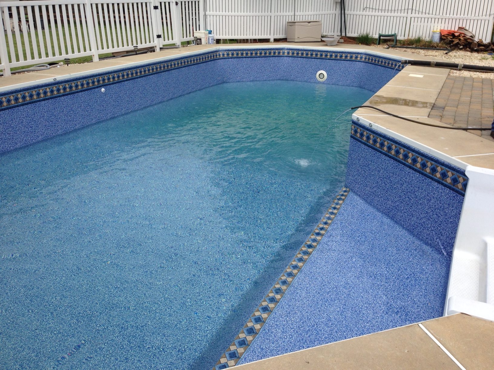 in ground pool with blue flooring and walling